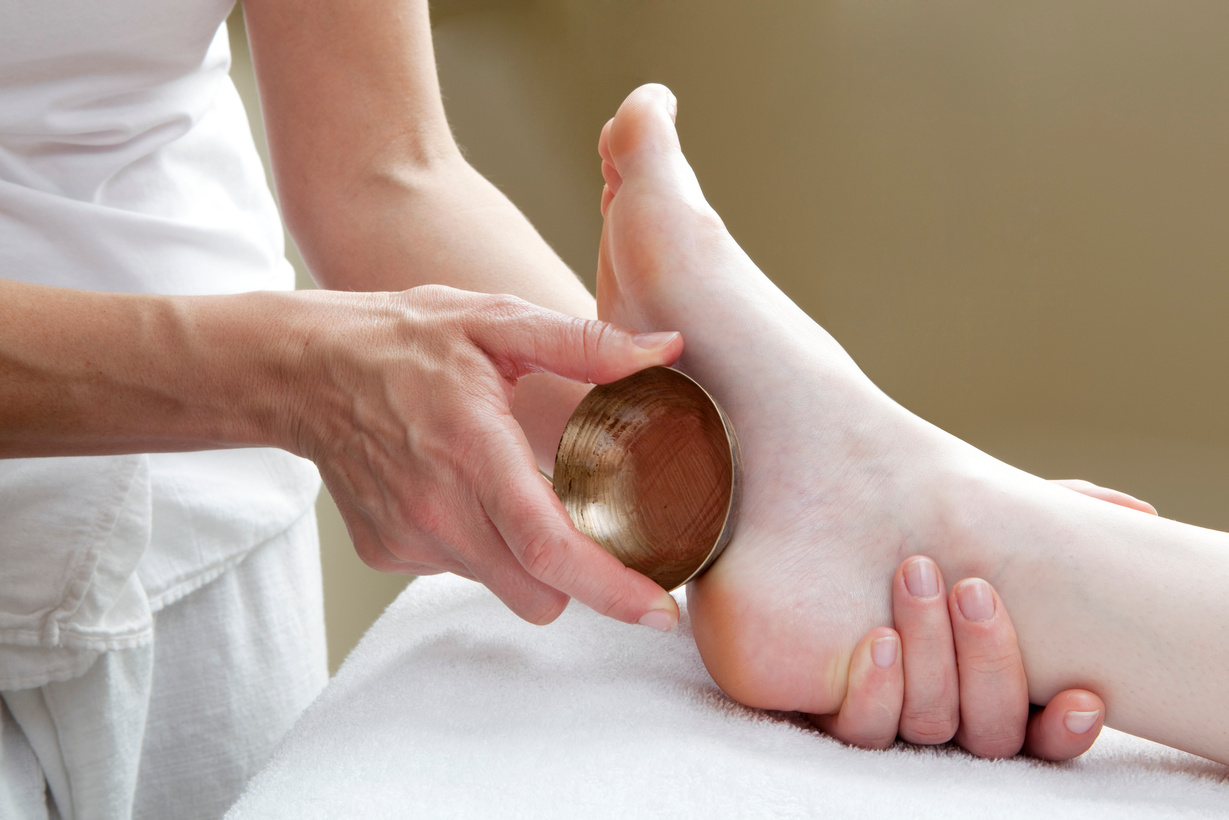 foot massage with bronze bowl
